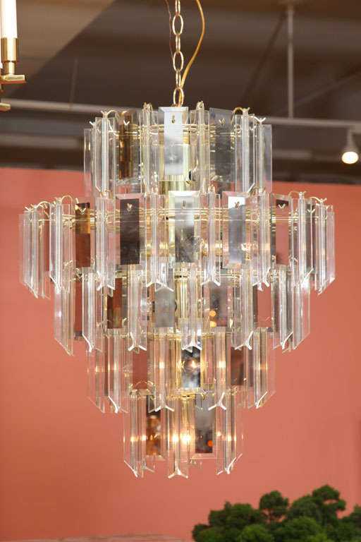 Extremely nice in condition and grand in scale, this is a beautiful 1960s Lucite acrylic prism and smoked glass panel 5 tiered, 13 light chandelier. Fixture is large, with 5 tiers.  The top and bottom tiers are narrower than the middle tiers which