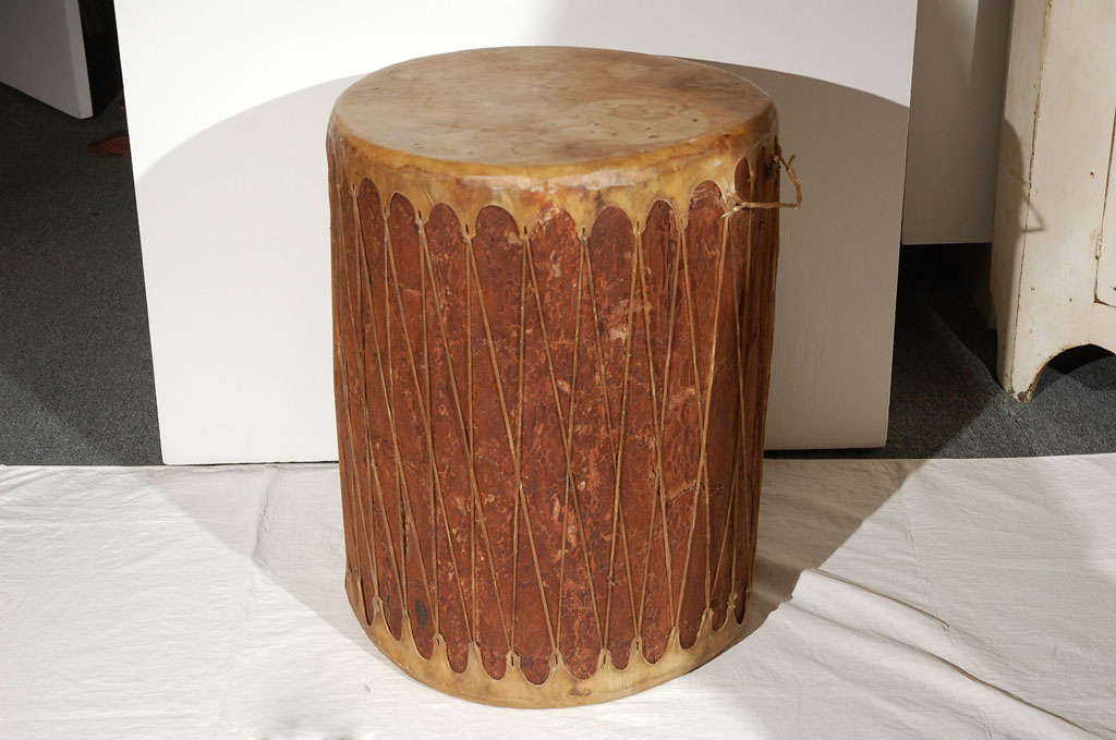 THE NAVAJO LORDS OF THE EARTH IN GALLUP,NEW MEXICO REGION WHICH REACHES NORTHEAST TOWARD TO TOHACHI, COYOTE CANYON AND STANDING ROCK IN THE NORTHWEST CORNER OF NEW MEXICO.THIS TRIAL DRUM IS COVERED IN ANIMAL SKIN AND TIED WITH IT TO.THE WOOD HAS ALL