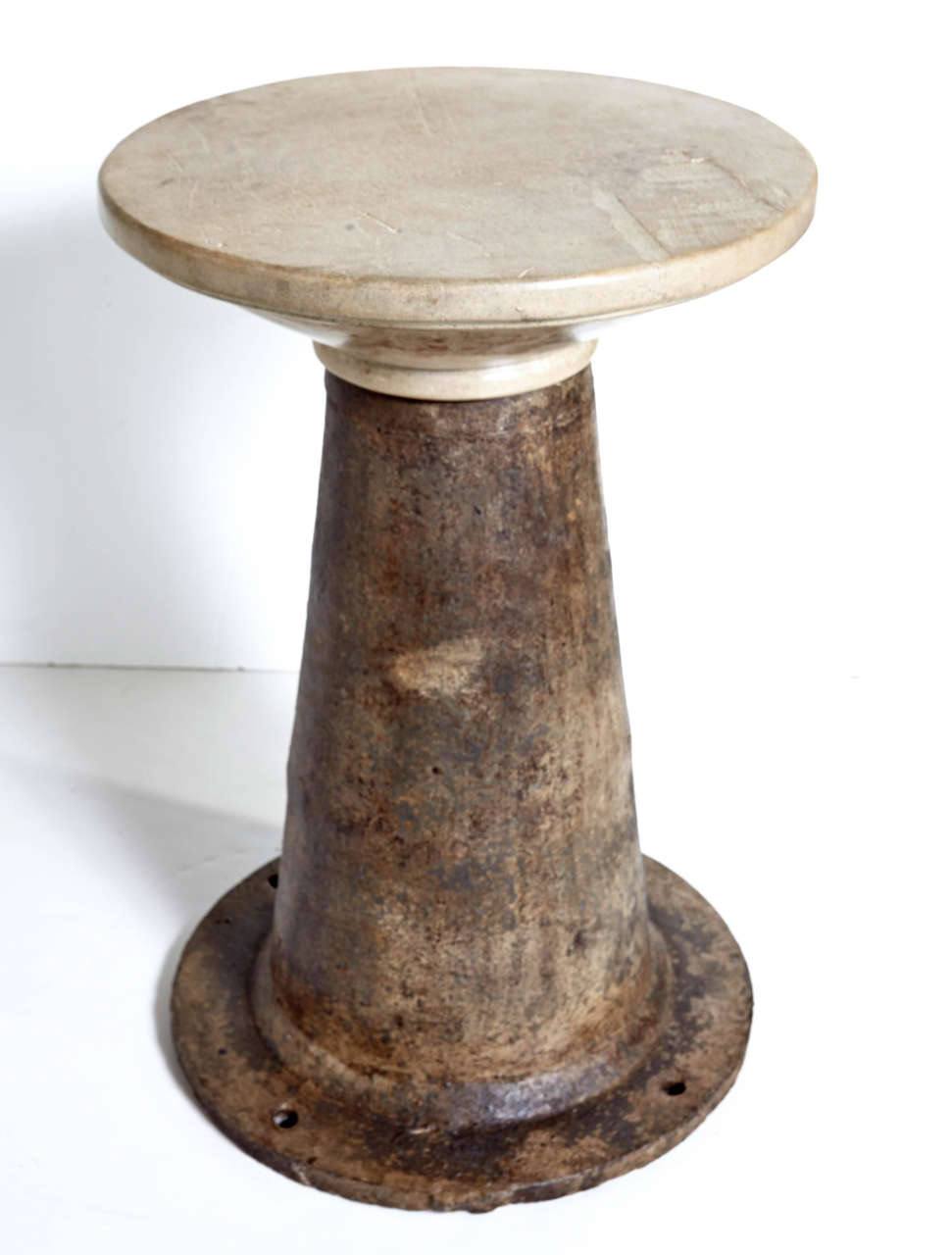 Vintage Industrial machine mount with limestone top as side table.