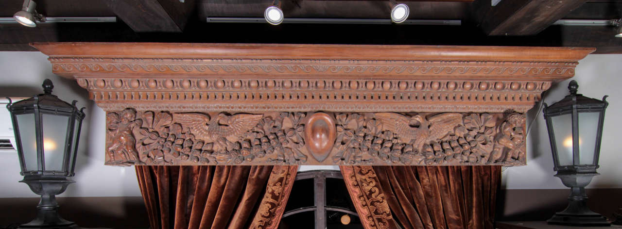 American early 20th century hand-carved walnut over-door. It was originally installed in the main gallery of Lynnewood Hall, the P.A.B. Widener estate in Elkins Park, Pennsylvania, one of the largest and most famous mansions of America, over the