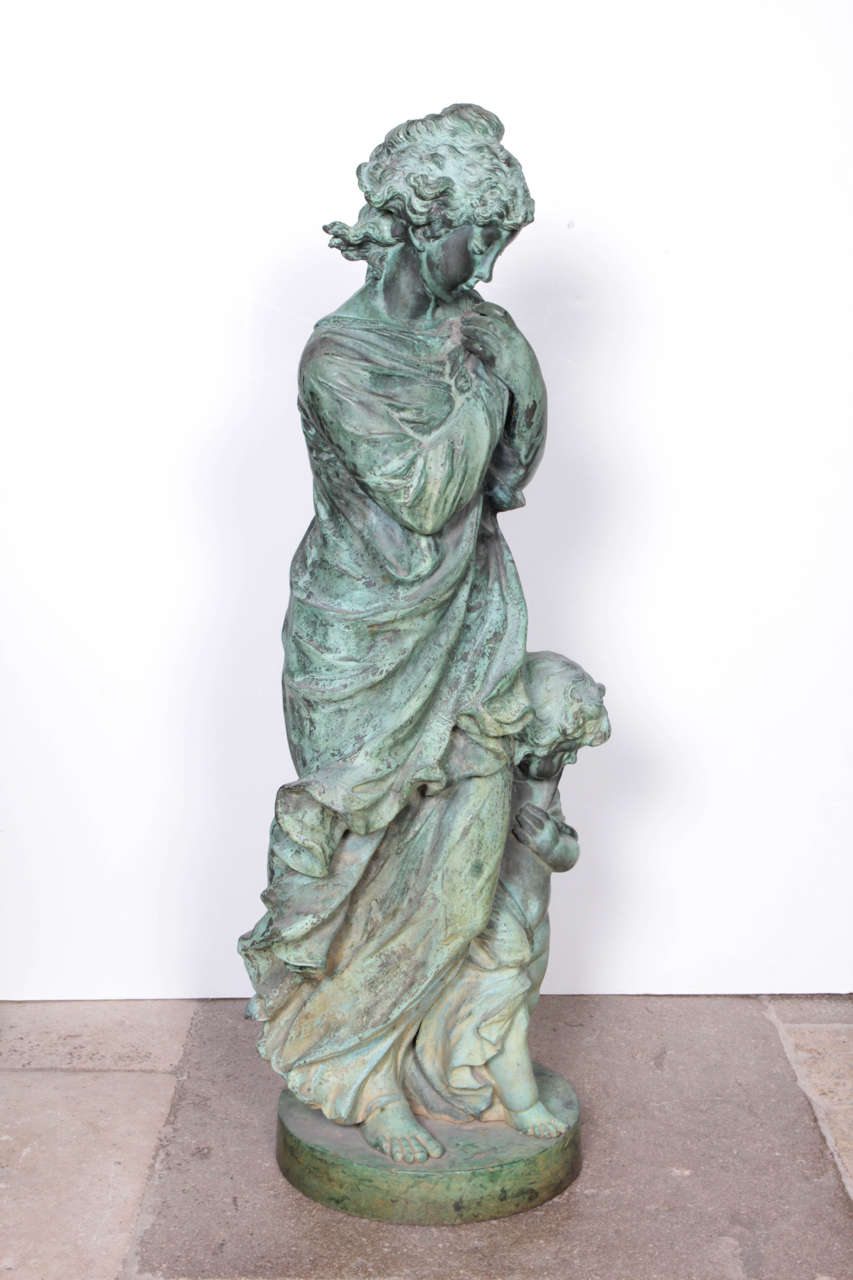 A recreation of a bronze figure representing winter by the artist Etienne Alexandre Stella, depicting a mother and child shielding themselves from winter's cold. Fabulous detail and patination.