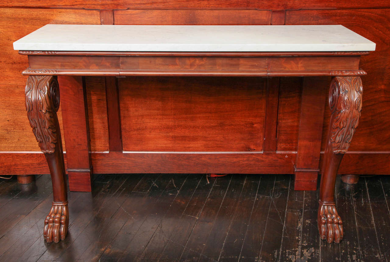 Early 19th century English, mahogany console with a drawer and a later marble top.