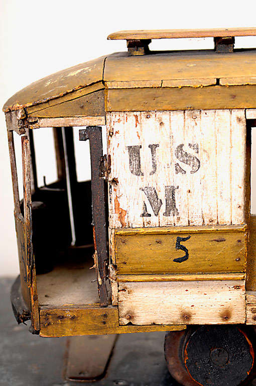 Wonderful intricately detailed early 20th c. hand made trolley car miniature.  This piece may have been made by someone who worked on a trolley or railway.  It has many details, such as doors that open and close, steering gears, turning wheels, and