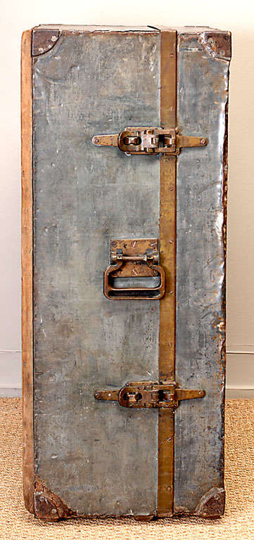 Trapezoidal shaped zinc-clad artillery trunk from WWI, used on a ship.  Can be used standing up, or lying on it's side.  Wonderful allover worn patina, with beautifully appointed mahogany interior compartments.  Great bronze strapwork, hardware and