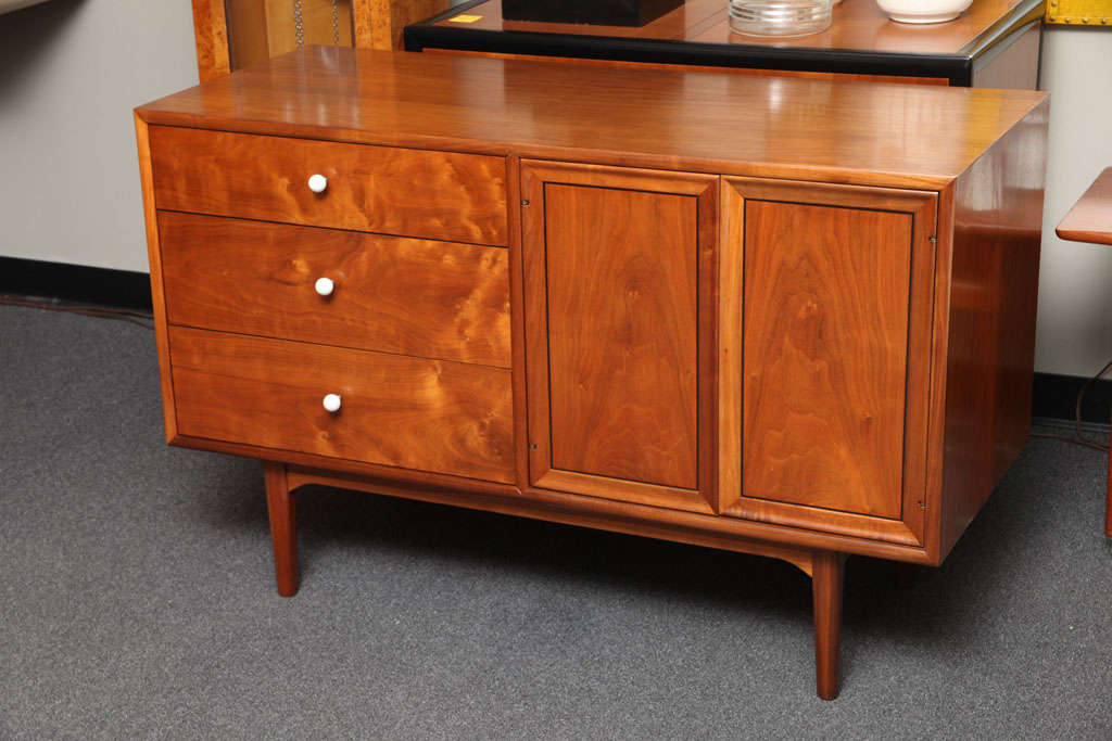 ...SOLD...Created as part of the Declaration Line by Stewart MacDougall & Kipp Stewart in the late 1950's, this buffet, sideboard or credenza fashioned in beautiful figured walnut and doors with ebony inlay stringing, features three drawers, the