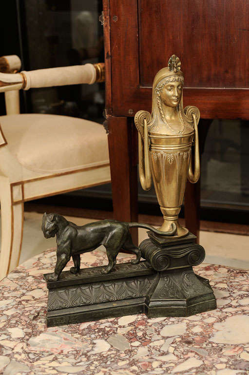 Each having brass Egyptian busts mounted with a peacock crown above a tapering urn. The whole resting on a bronze plinth decorated with an ionic capital and a panther.