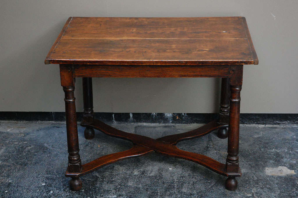 An English Cross-Stretchered Oak Table from the William and Mary Period with hand-turned baluster legs.