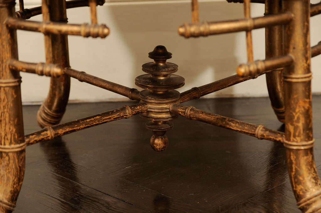 This French Napoleon III period giltwood stool has four bamboo form legs, each with fretwork brackets and joined by stretchers centered on a turned device, all supporting a tufted upholstered seat.