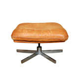 Whip stitched leather ottoman on stainless base by De Sede