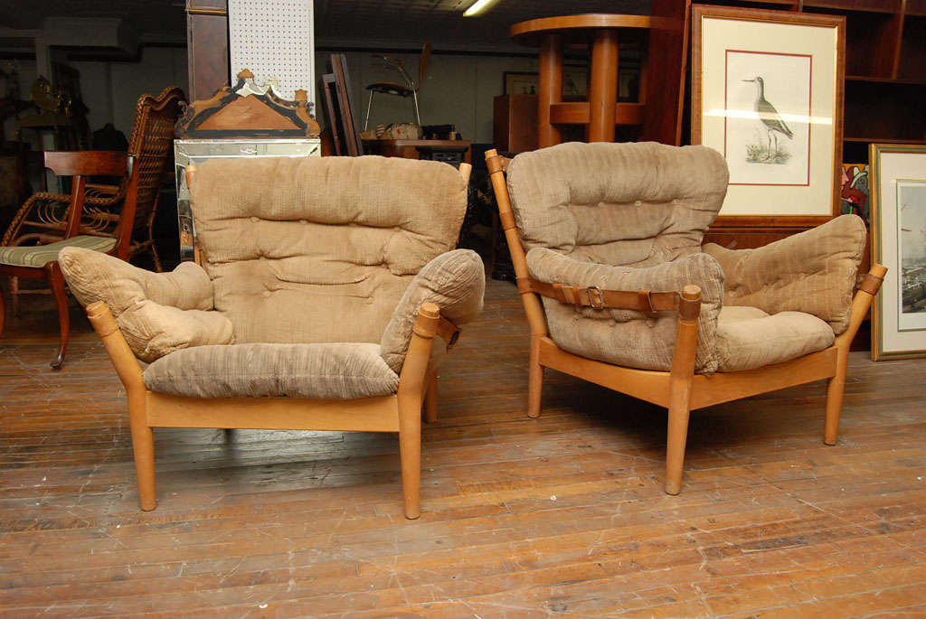 Pair of Danish Modern lounge chairs, oak frames with leather straps and comfortably upholstered with fat corderoy cushions.