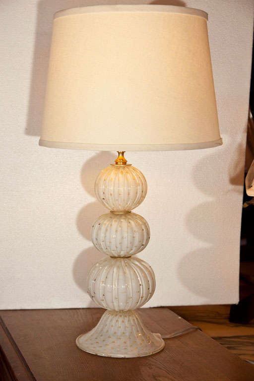 Pair of Italian hand-blown murano glass lamps in white ribbed sphere glasses and brass discs, each piece has 24kt. gold bubble flecks.