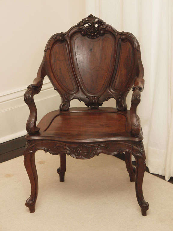 One rosewood armchair in the Louis XV taste; foliate carving at the bottom rail and top crest; tripartite shield back; only one available