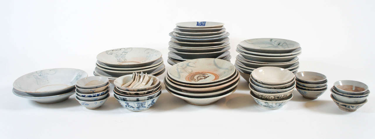 Large collection of antique 16th-19th century Chinese 'kitchen ming' Swatow ware pottery consisting of deep plates from large to medium, bowls of various sizes, and spoons. All having various underglaze blue, gray, and brown painted designs and