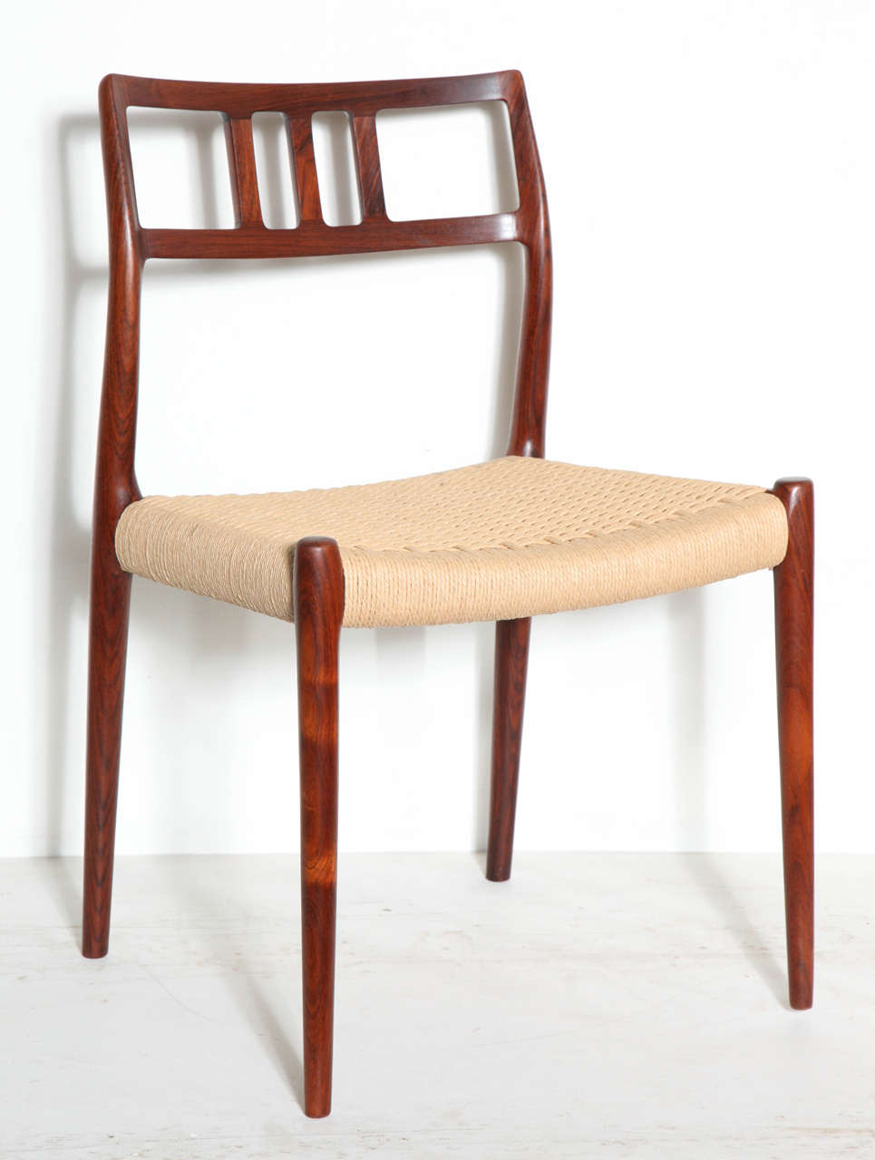 Vintage 1960s Rosewood Dining Chairs by Niels Møller. 

These Vintage Danish Dining Chairs are the classic No. 79 chairs. The seats of this set are in the traditional paper-cord. We can also reupholster them to fit your style. Ready for shipping,