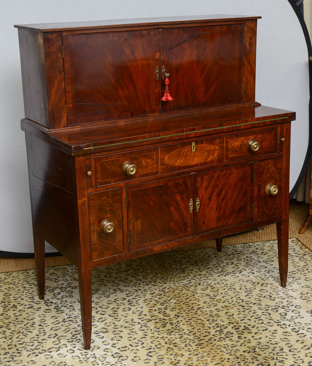 This is a very nice antique American office desk which also has drink compartments.This comes in two parts the top has pigeon holes and some drawers which all run fine.To the base there is a flap which pulls down with a writing slope covered with a