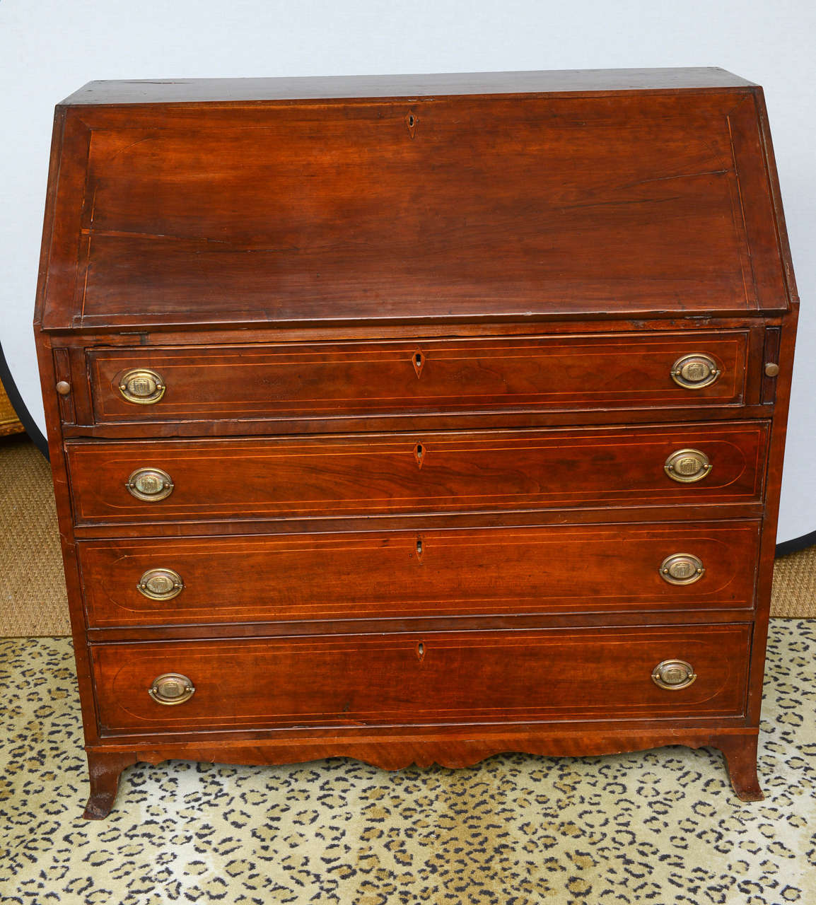This is a very nice solid mahogany American writing desk bureau. It sits on bracket feet and has satinwood string inlay to the drawers with dove tails joints and solid oak drawer linings ,also with solid brass handles which may have been replaced