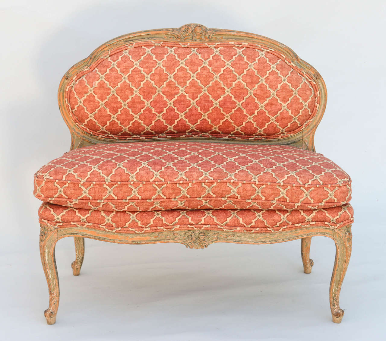 Child-sized canape, in the Louis XV taste, a perfect size for small pets, having a distressed painted finish, its shaped padded back in molded frame, centered by foliate cresting, flanked by S-scrolls, loose down cushion, its seatrail with similar