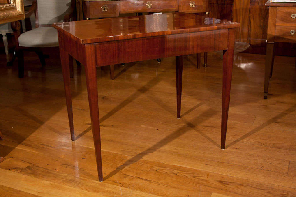 Fine neoclassic rectangular-shaped side table on thin tapered legs in solid mahogany and mahogany veneer, originating from Dresden and of the original possession of the Sachsen-Coburg-Gotha royal family.
