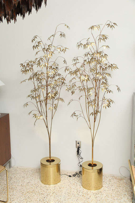 Not one but TWO life-size brass trees by Curtis Jere. Both trees are lit from below by a single flood, concealed in the base. Wonderful for flanking a fireplace or buffet, or as a dramatic foyer element. Signed and dated. Price is for pair.