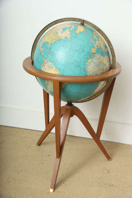 THIS BEAUTIFULL GLOBE WAS DESIGNED BY EDWARD WORMLEY IN THE 1950,S FOR RAND MCNALLY.IT SITS ON A SOLID WALNUT STAND WITH BRASS CAPS AT THE TIPS OF THE LEGS. THE GLOBE IS 16