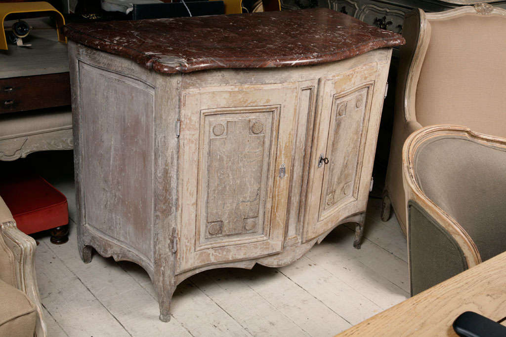 Oak buffet with 2 doors enclosing a shelf, with a marble, red/brown top.