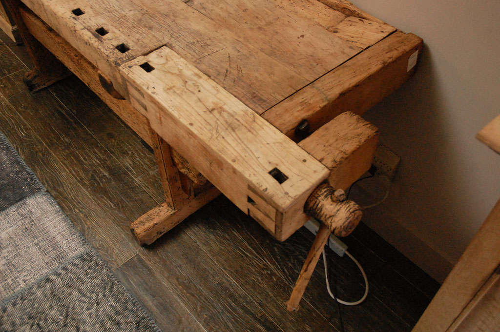 Rustic 19th-century English wood-worker's bench in bleached wood with vises on a trestle base. Can be used as a side table, sideboard, serving table or console. Industrial pieces such as this take on an almost art-like appearance depending on their