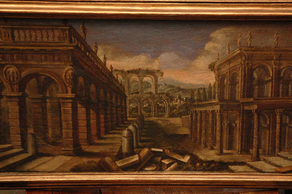 18th-century Italian capriccio painting. Mounted in a beveled gilt wood frame, the oil on canvas painting depicts a dreamy expanse of Roman architectural ruins. 

A capriccio is a genre of painting that falls under the more general term landscape