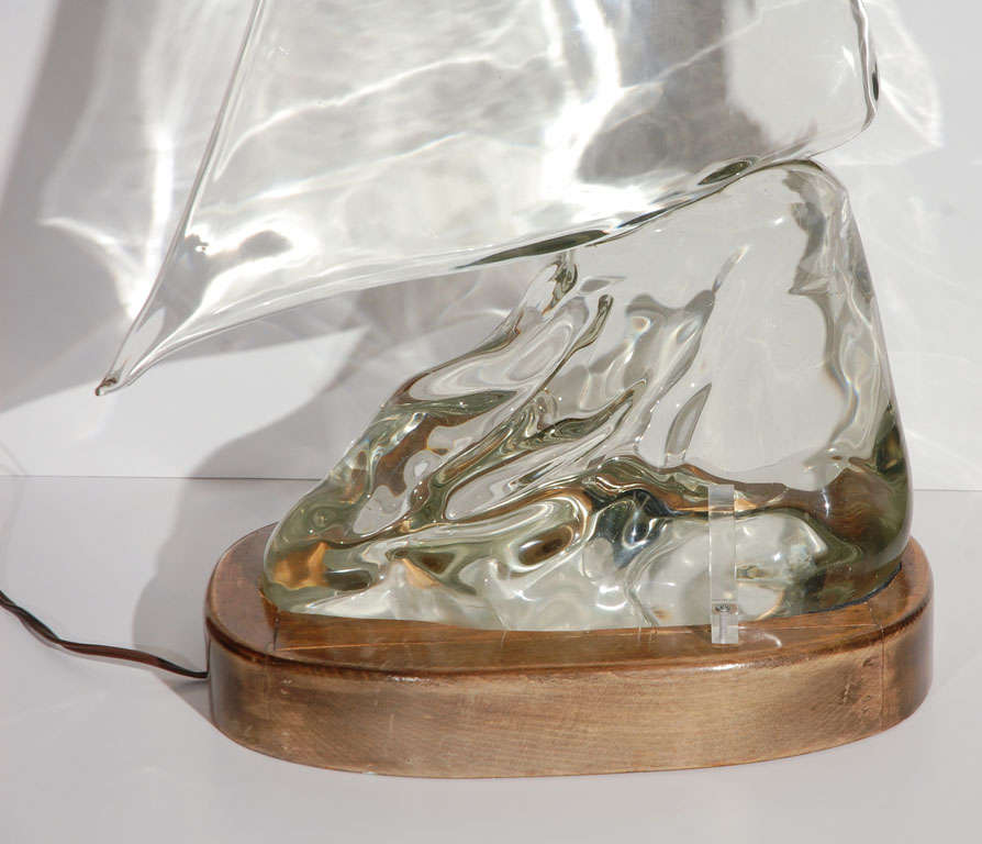 A wonderful Luciano Gaspari for Seguso Murano glass sculpture of a sailboat riding a cresting wave on a wood frame. Base has been repainted black. See image 7 and 8 for repainted base. There is a light on the base to shine on the sculpture from