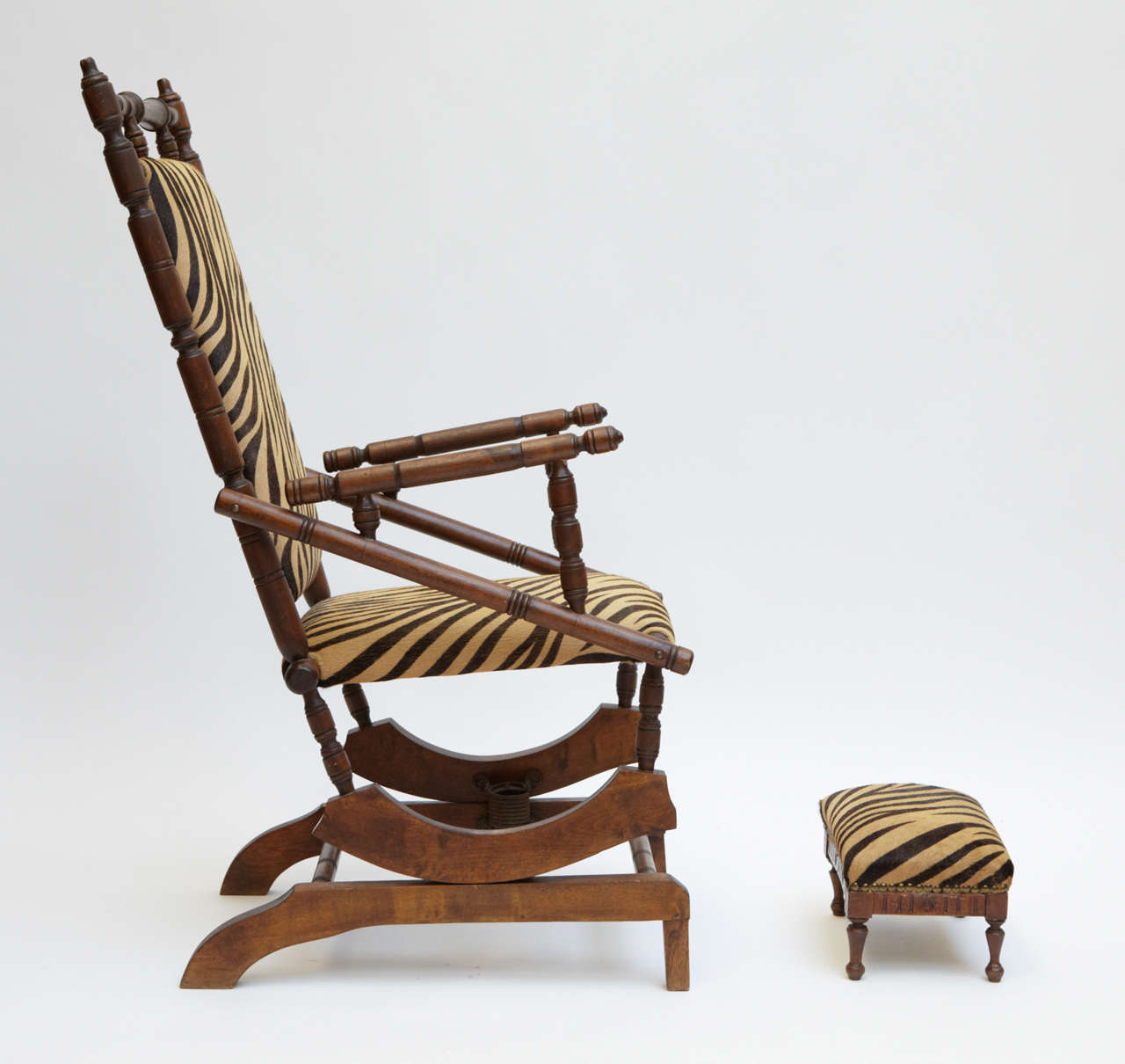 French Napoleon III rocking chair with footstool, covered with fabric horsey.