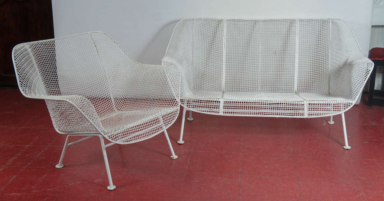 Vintage iconic midcentury Russell Woodward design white mesh and iron garden loveseat and armchair. Chair dimensions: 27.5