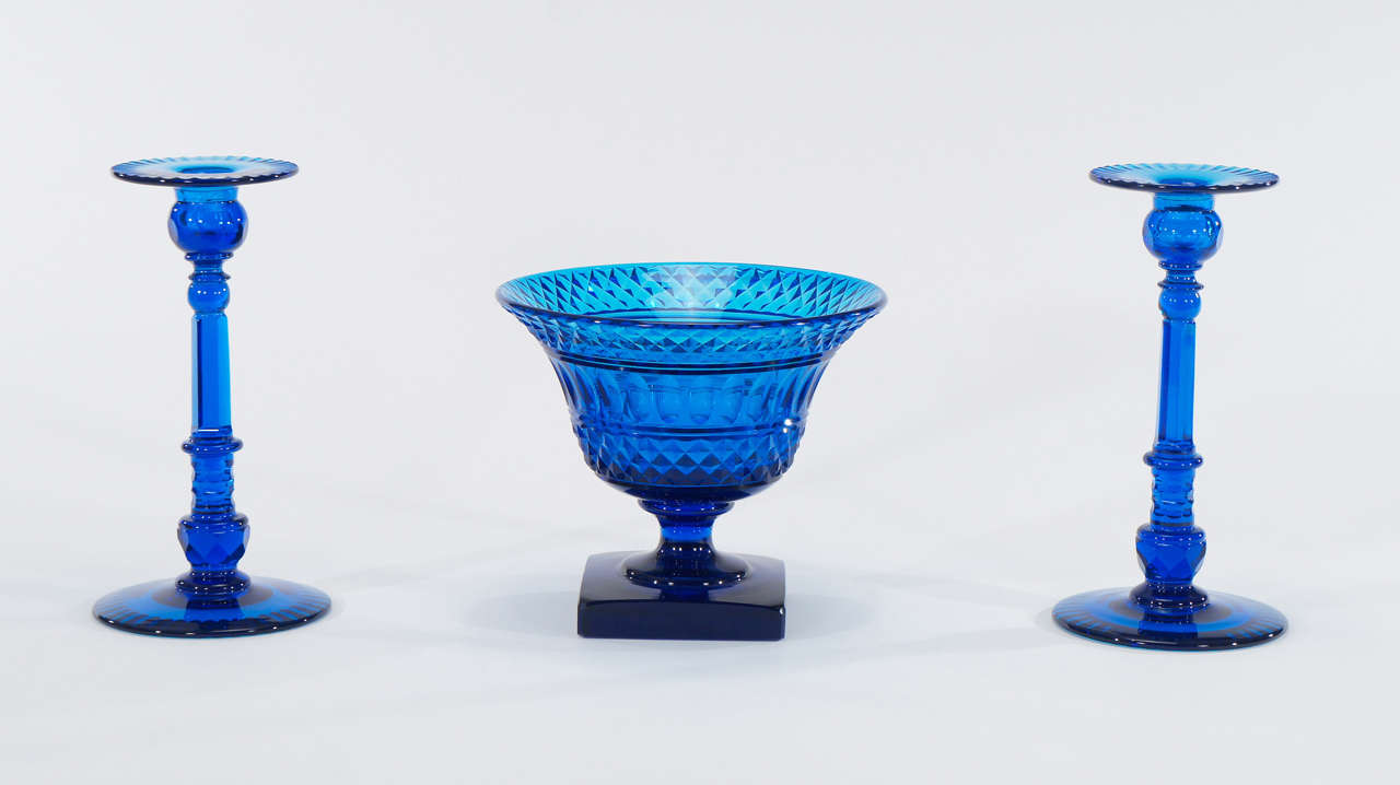 This is a dramatic large centerpiece set made by Steuben in their finest period. The rich deep turquoise blue is the perfect focal point on a table, sideboard or in a collection. Each piece is hand blown crystal that is masterfully cut with clean