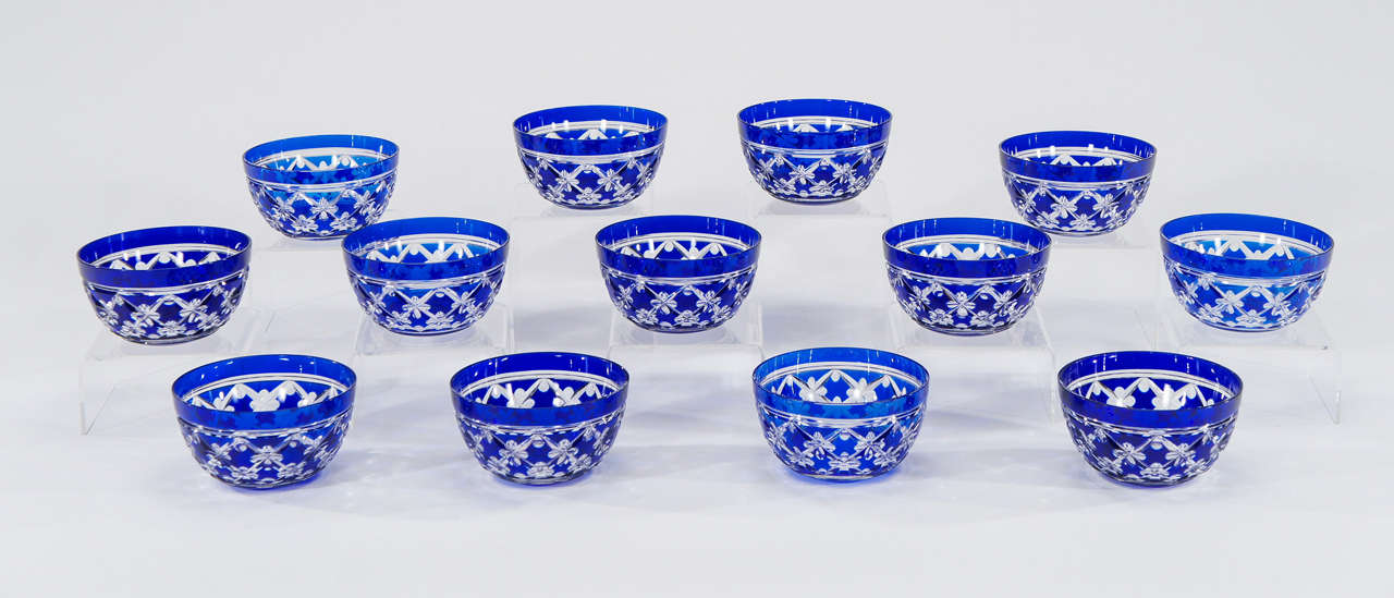 A rare set of 12 handblown crystal dessert or soup or fruit bowls with vibrant cobalt blue overlay and cut to clear. Made by Val Saint Lambert in the rare and sought after 