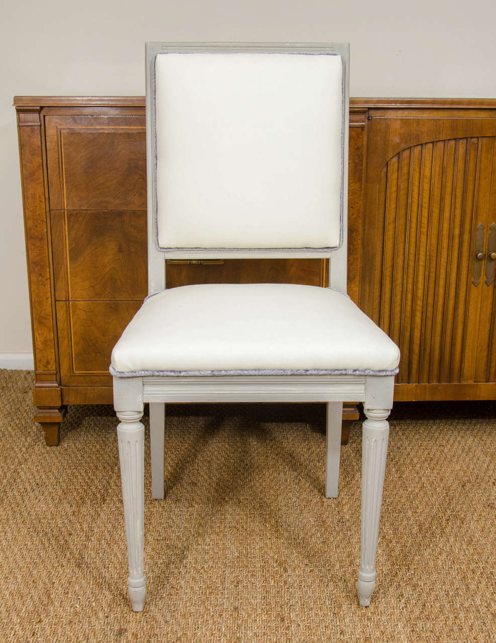 A set of six charming dining chairs, painted in a light gray.