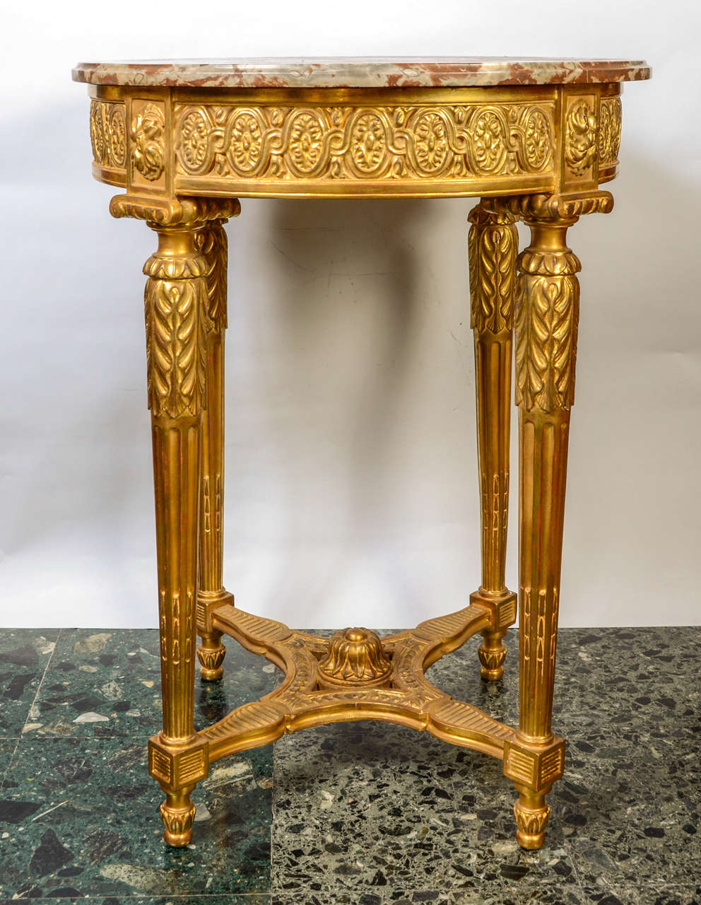 Round gueridon, in wood gilded with real gold leaves .
