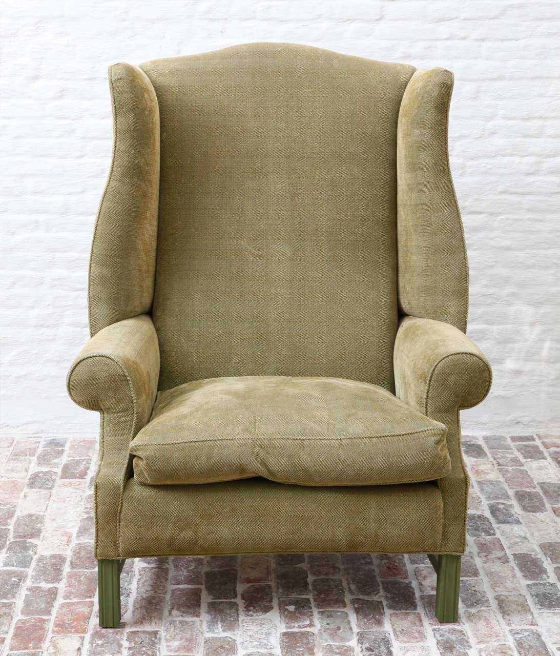 Green painted oversized English wingback armchair.