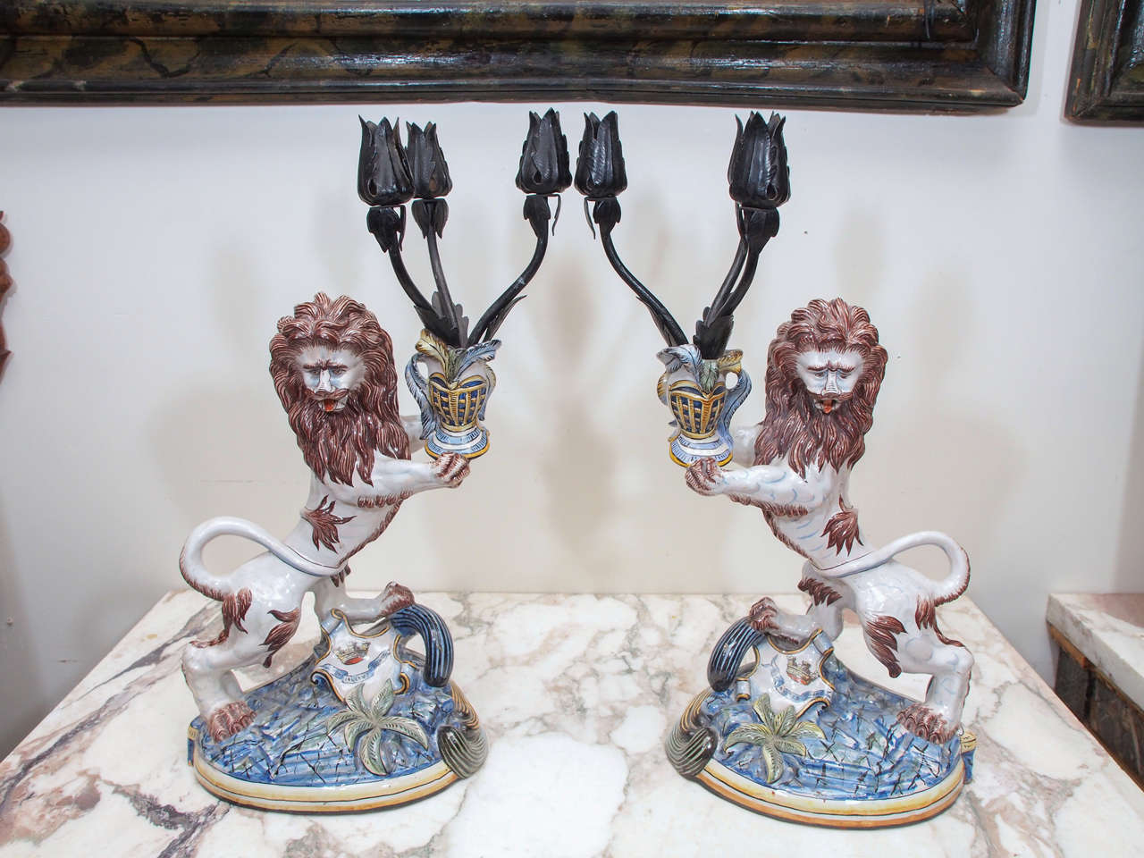 Pair of St. Clement faience lion form candlesticks with iron arms and candle holders. Signed SC K and G which would be St. Clement, Keller and Guein
which bought the factory in 1892. Dated 1910.