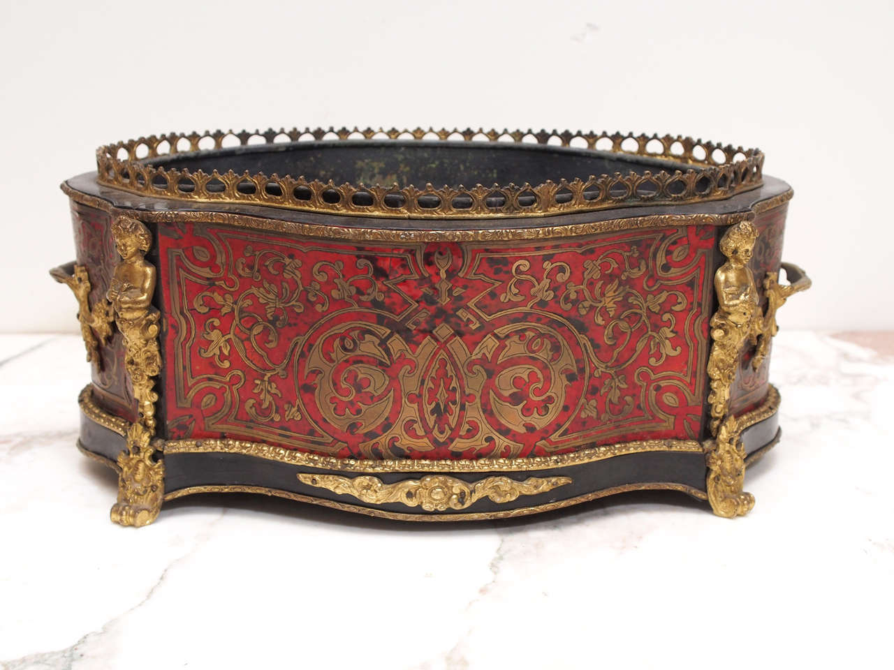 French Napoleon III Boulle (tortoiseshell and brass inlaid) jardiniere with tin liner. Having four panels of boulle, two gilt bronze handles and four caryatids on each corner and pierced railing around the top.