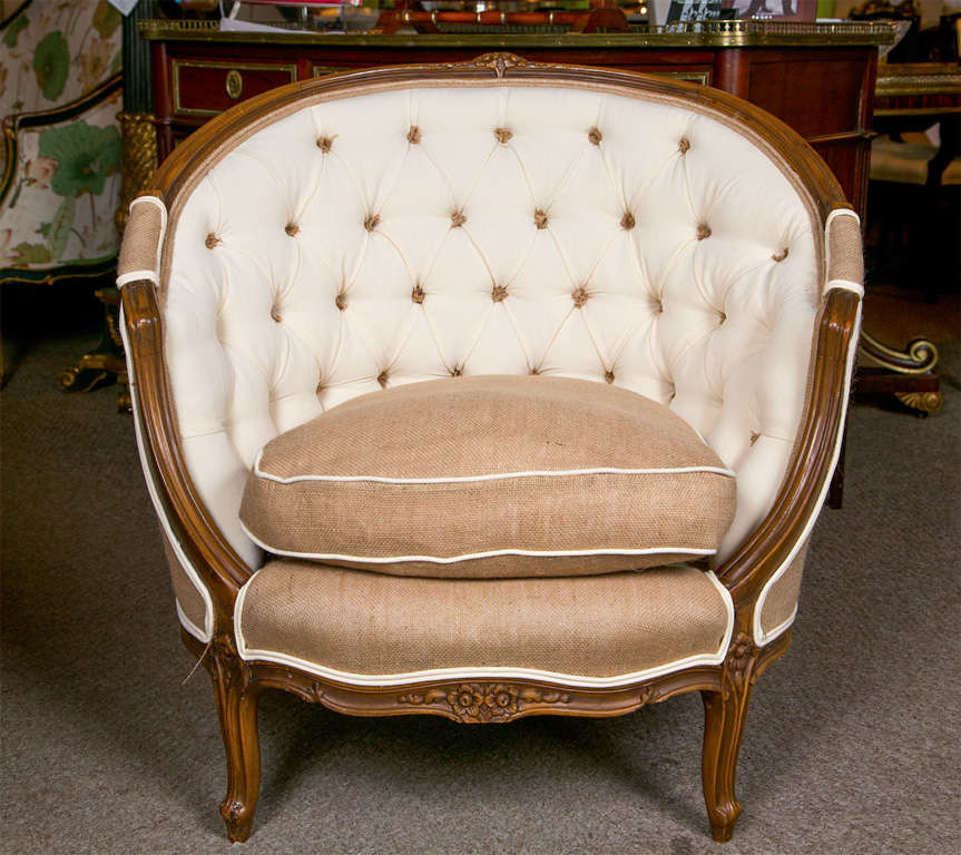 Pair of French Louis XIV style walnut bergere chairs, circa 1930s, the domed round back with tufted padding, cushioned seat and padded rear upholstered in burlap, raised on short cabriole legs.