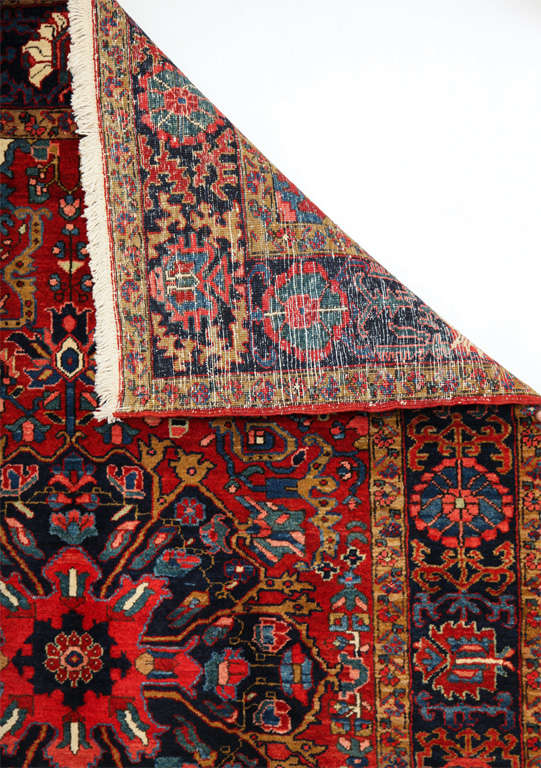 This Persian Heriz carpet created, circa 1920 consists of a cotton warp and weft, hand-knotted wool pile and organic vegetal dyes. Depicted are an exceptional medallion, border and field as shown through the level of detail, the proportionality of