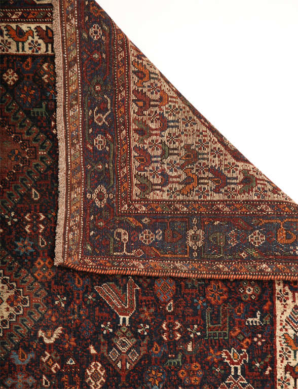 This Persian Qashqai Neyriz carpet consists of a wool warp, wool weft, hand-knotted pure wool pile and organic vegetable dyes. It is a beautiful example of a classic Qashqai design depicting peacocks, roosters, sheep and flowers throughout its