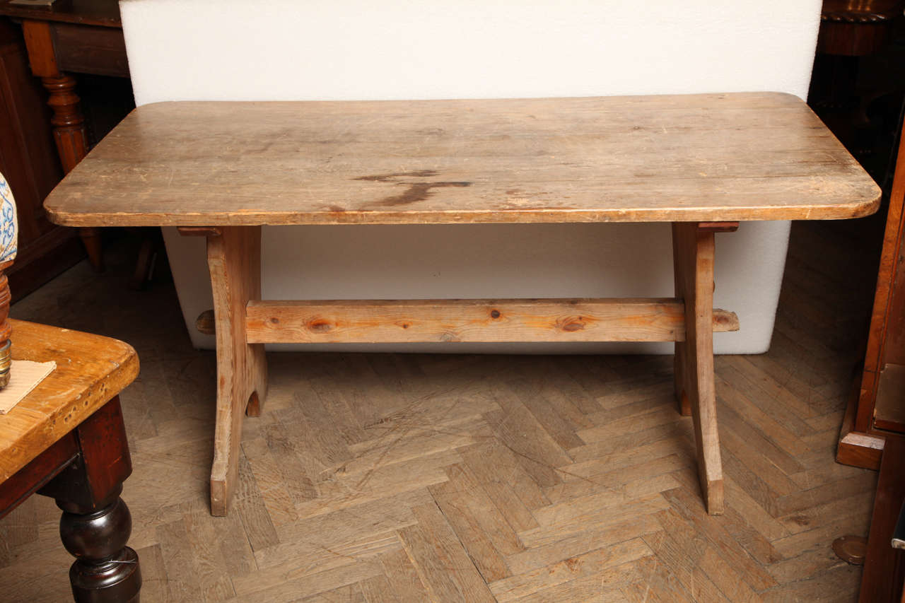 Pine trestle end table, UK, circa 1850.