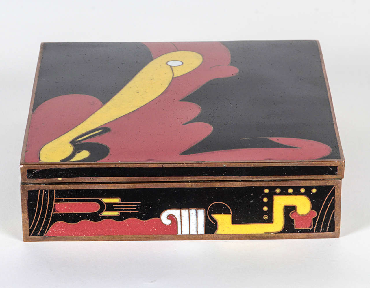 CHINESE ART DECO

Covered Box c.1930

Cloisonne enamel in a fantasy motif of red, yellow, black and white abstract designs on a bronze body with a blue enameled underside and a wood lined interior
