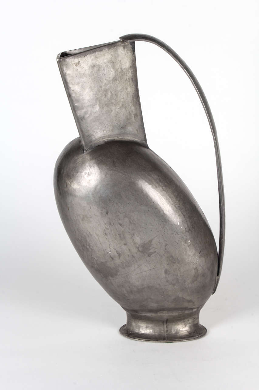 1950’s ITALIAN DESIGN

Futurist pitcher  c. 1950

Handwrought and hand hammered pewter in an overall footed ovoid form with a traingle form spout body and an elongated arching contoured handle 

Marked:  PELTRO with lion, MADE ITALIA

The