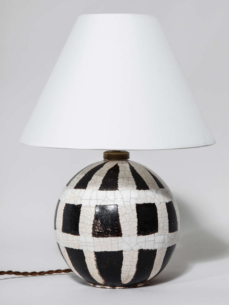 This spherical lamp base has a white and beige fishnet design on a brown ground.
Has been rewired to U.S. standards.
Signed: 