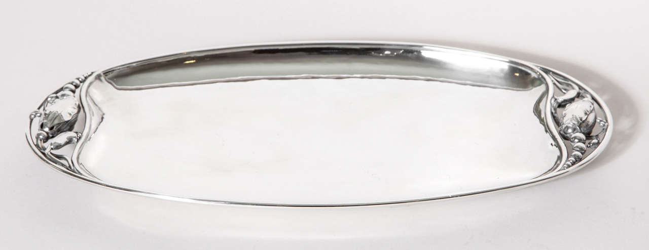 An elongated open tray, the ends with openwork beaded buds and fronds enclosed by wire rim.
Hallmarks: Georg Jensen mark for post-1945/ 2 D/ DENMARK/ STERLING
19 ozs

Variety of other Georg Jensen pieces available.

(Price shown is reduced price, no