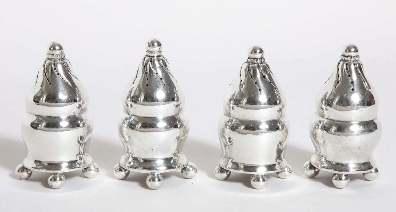 Each with baluster shape, on four ball feet, the top pierced in swirls, with ball finial, the base with slip on cap.
Hallmarks: Georg Jensen Mark for 1925-1932/ 410/ GI 925 S
5.5 ozs

Variety of other Georg Jensen pieces available.

(Price shown is