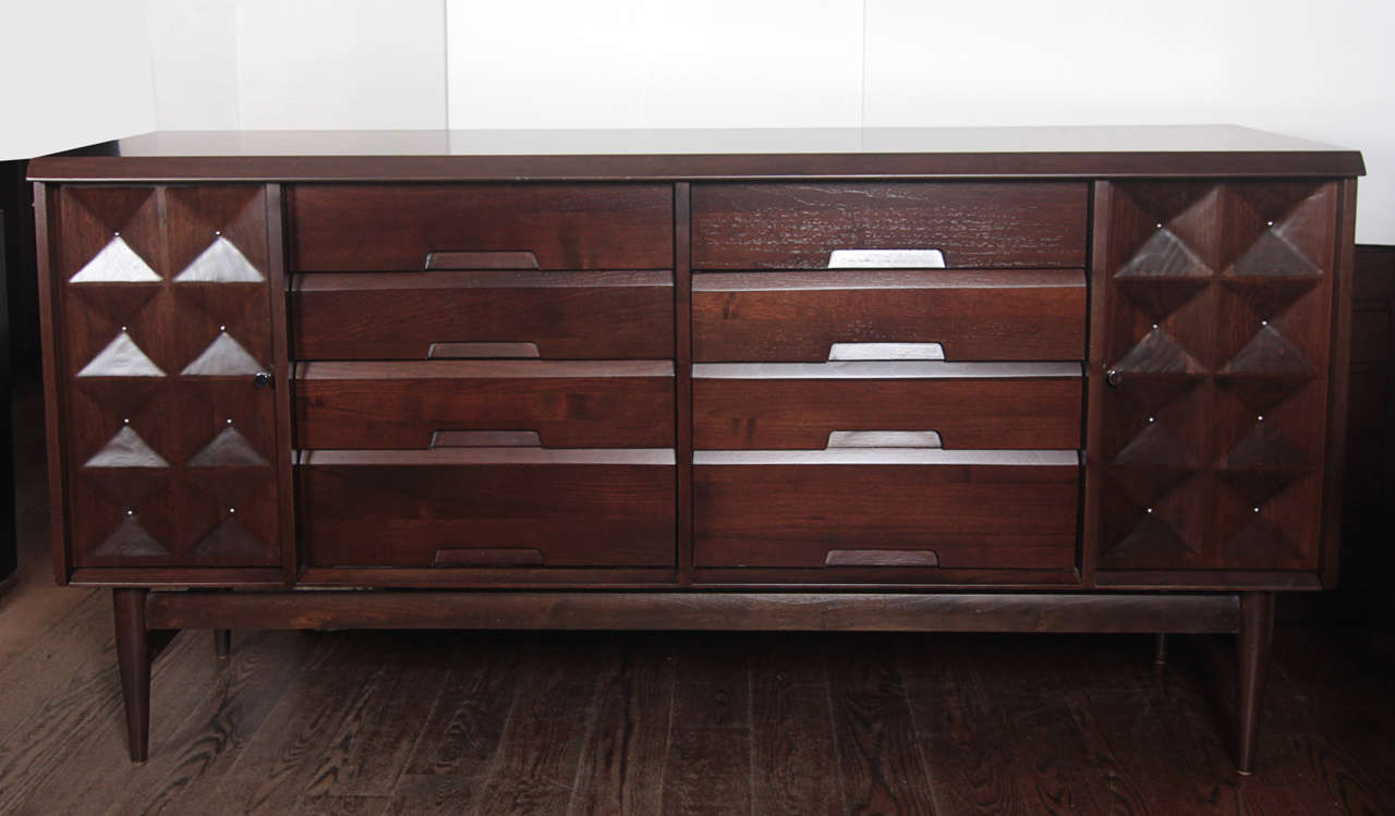A newly refinished sideboard/credenza by Edmund Spence. Articulated doors and nickel accents. 8 drawers and 2 side doors with adjustable shelves.