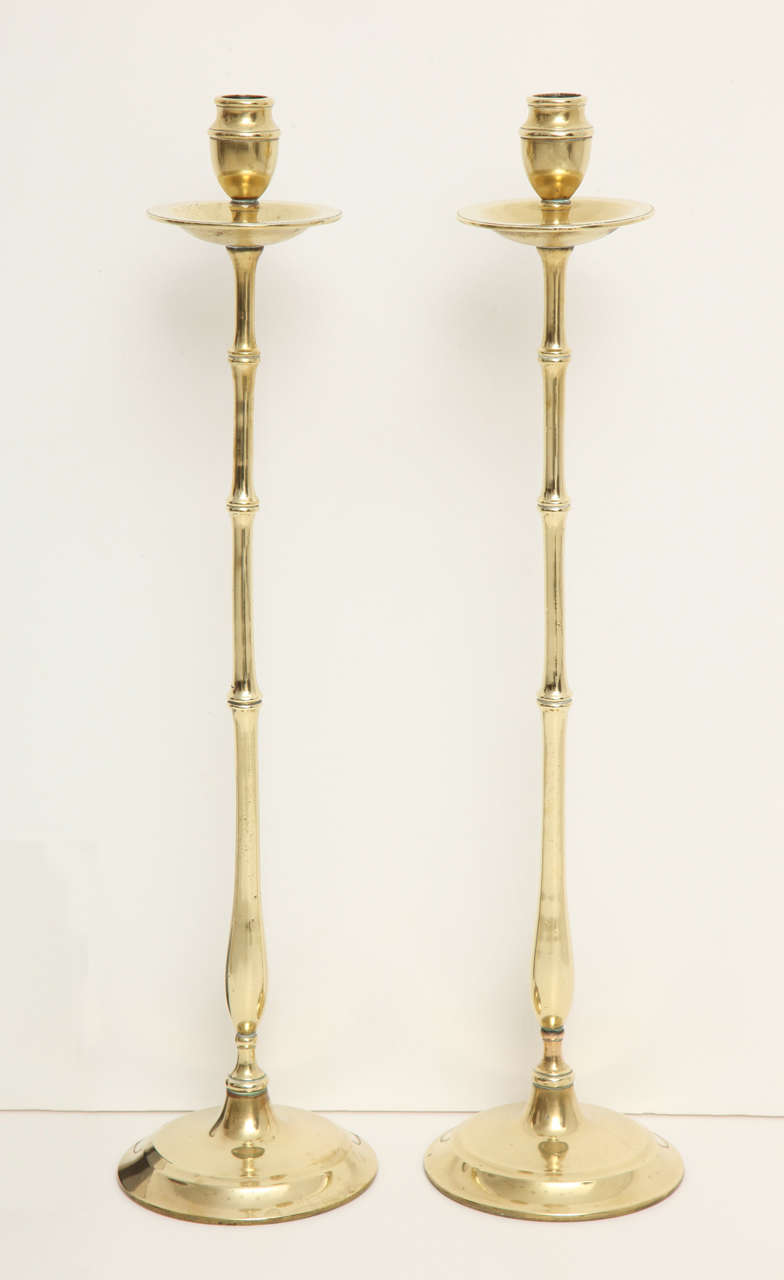 A fine pair of English Regency brass faux-bamboo candlesticks with weighted bases