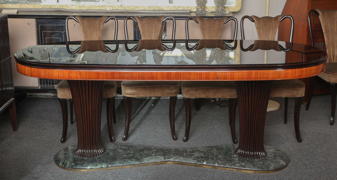 Stunning large dining table made in Milan 1940s designed by Dassi. Black opaline glass top on rosewood with two carved channeled pedestals, base in marble.
   