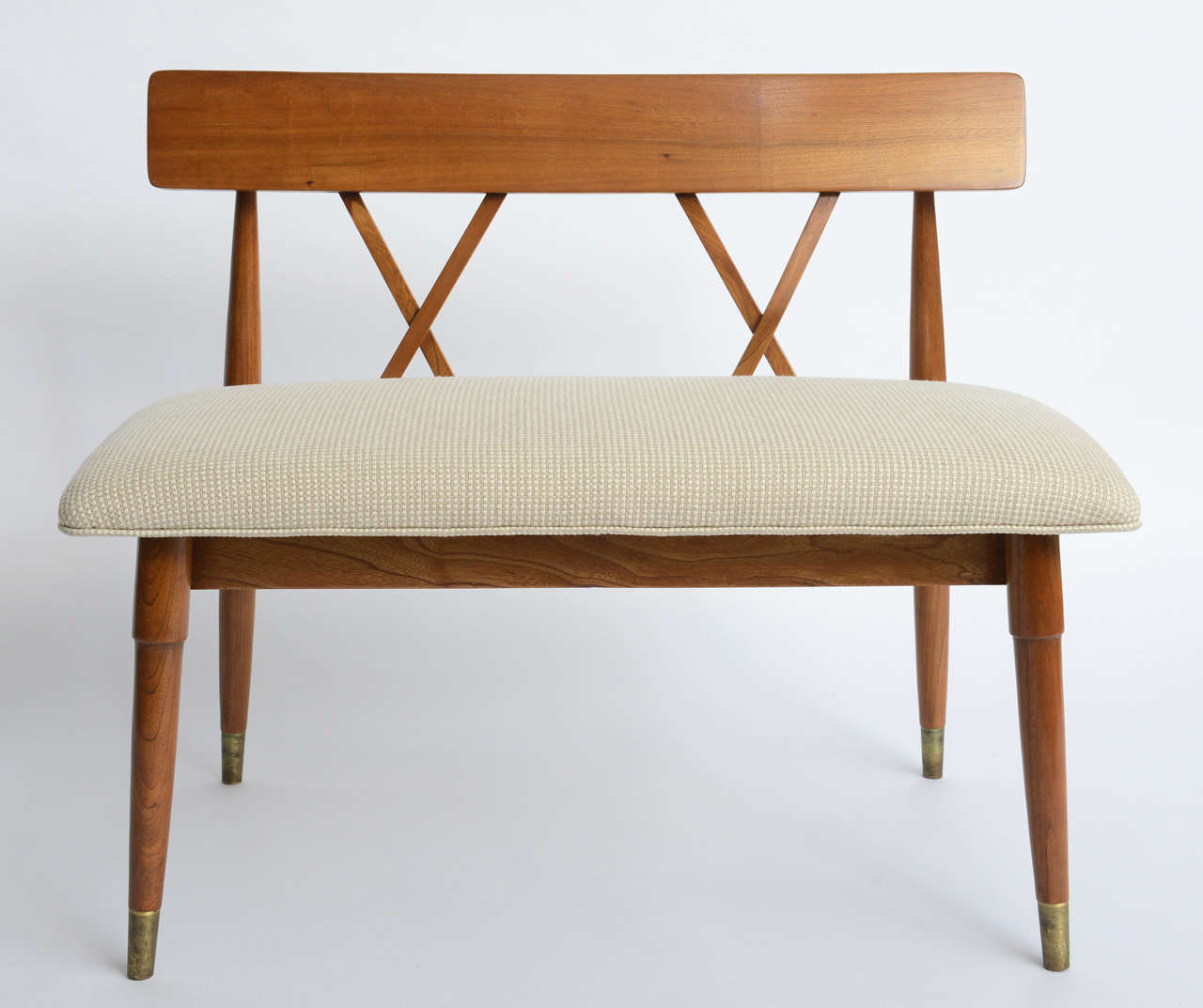 ....SOLD...With stylish simplicity and clean design this blond wood bench or two-seat is a Mid-Century Paul McCobb inspired creation. Totally restored, new neutral upholstery. Wonderful crossed back spines and aged brass sabot leg caps. A bit of